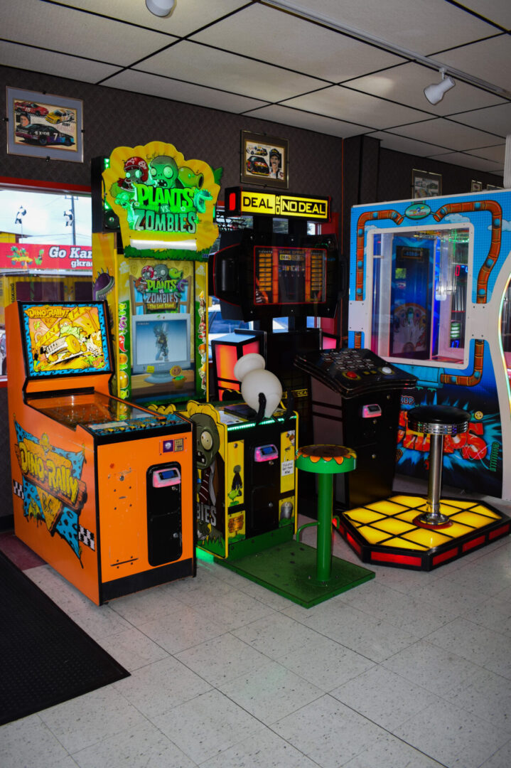 Arcade game station of Dino rally, plants vs zombies and deal or no deal