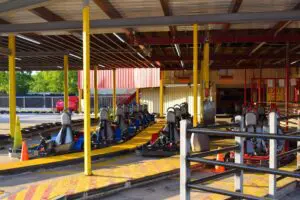 Go karts, two seaters and super karts arranged in the pit lanes. | Go-Kart Raceway